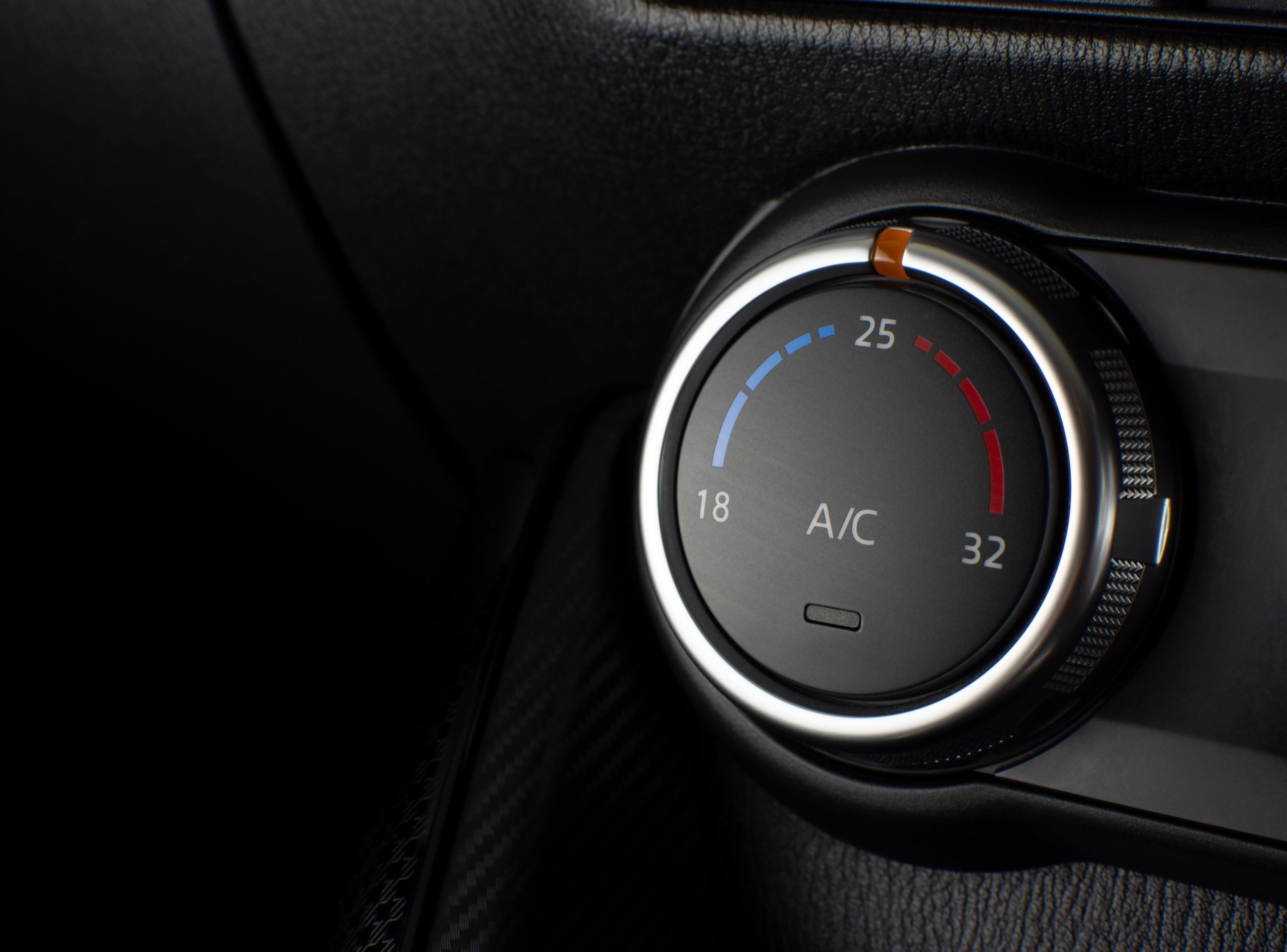 Air conditioner button for temperature climate adjustment in a car.